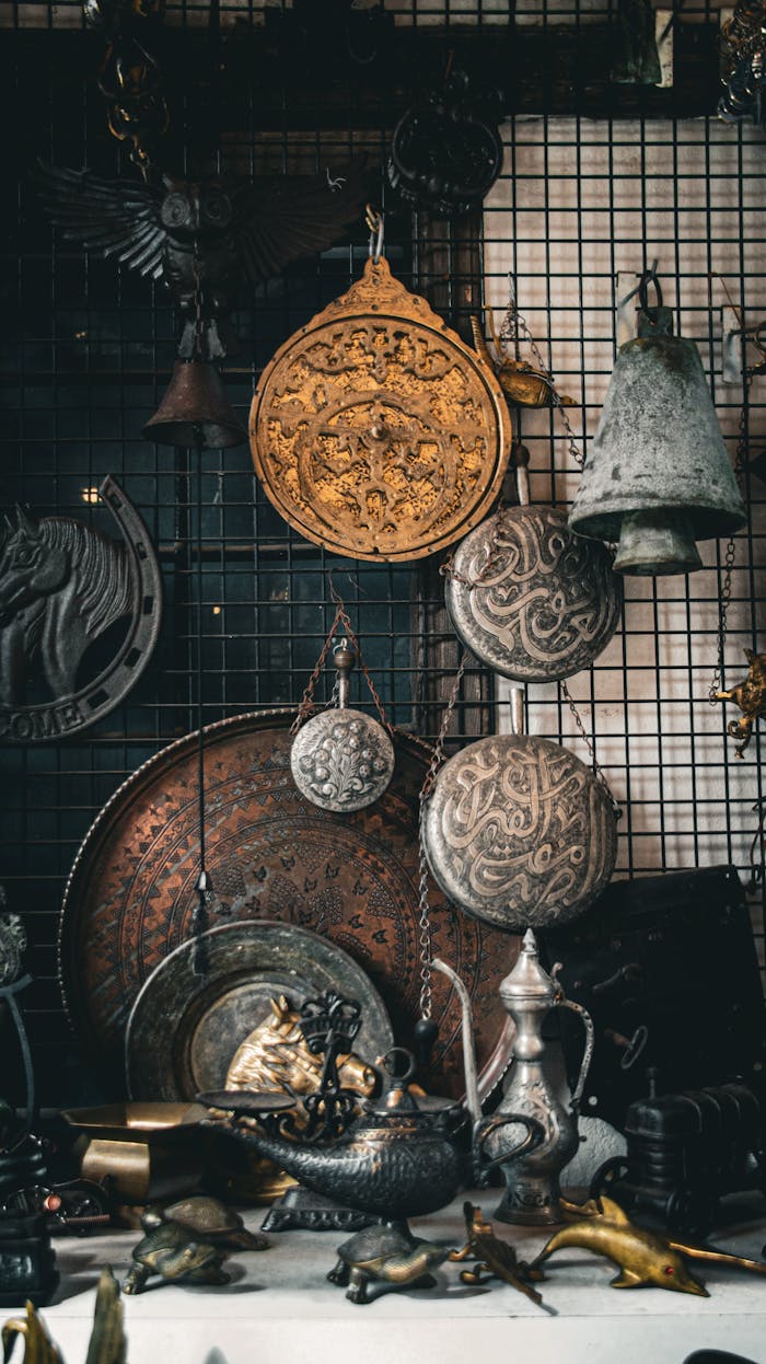 A collection of Middle Eastern antiques and artifacts displayed on a metal grid wall.